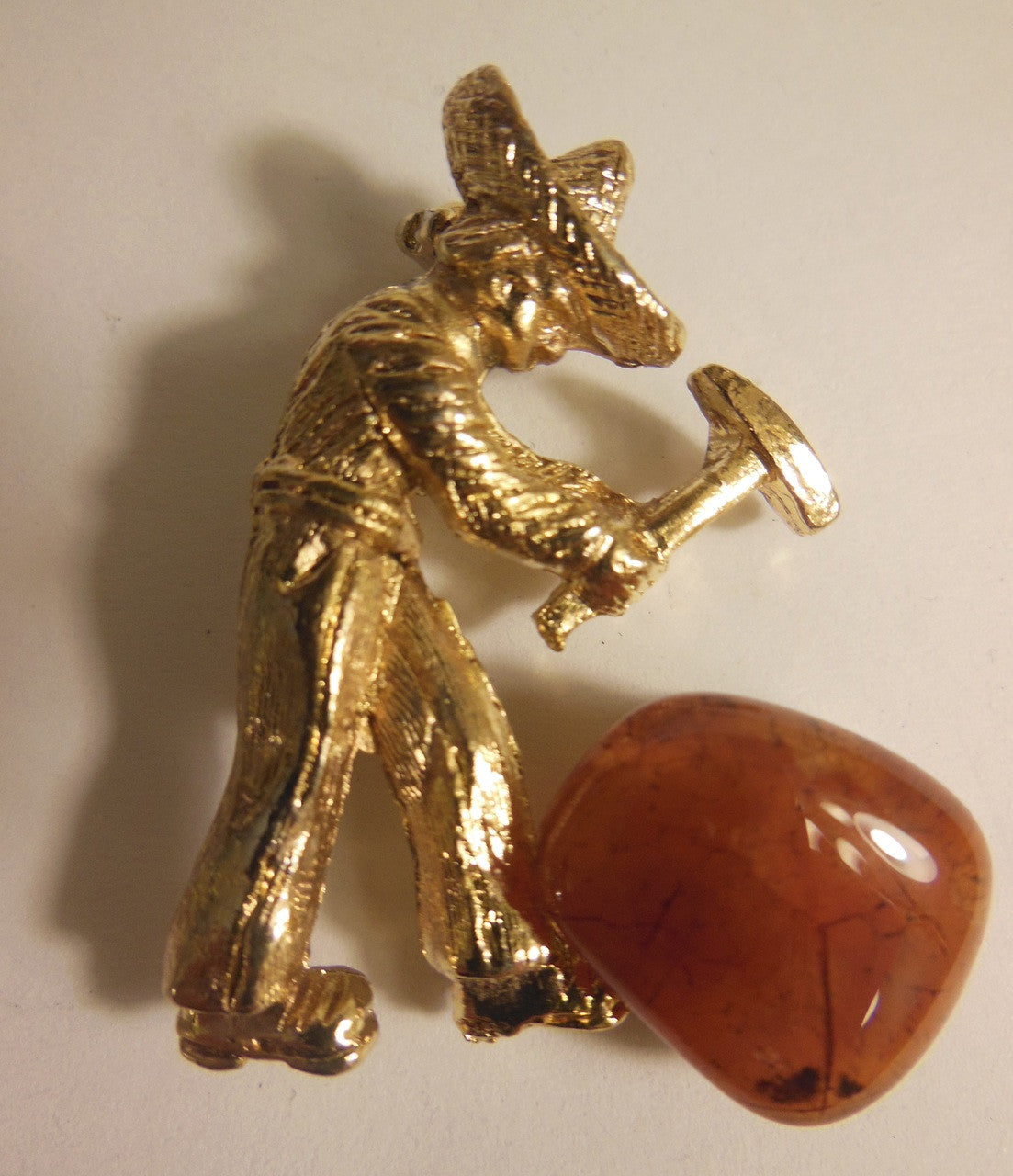 Vintage brooch. At work in the quarry hammering gemstones
