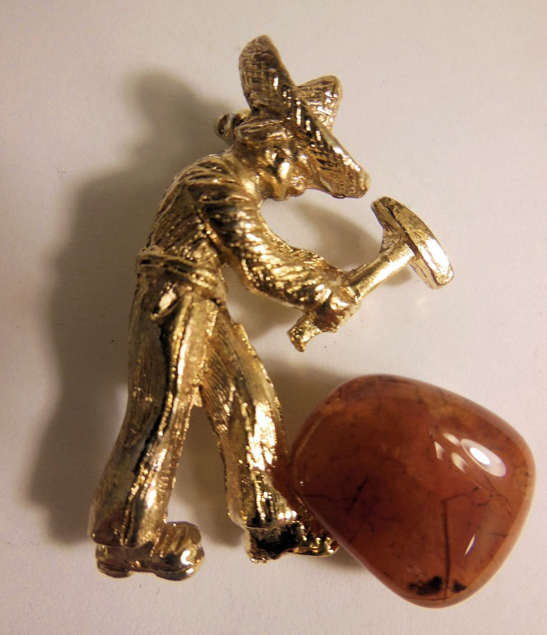 Vintage brooch. At work in the quarry hammering gemstones