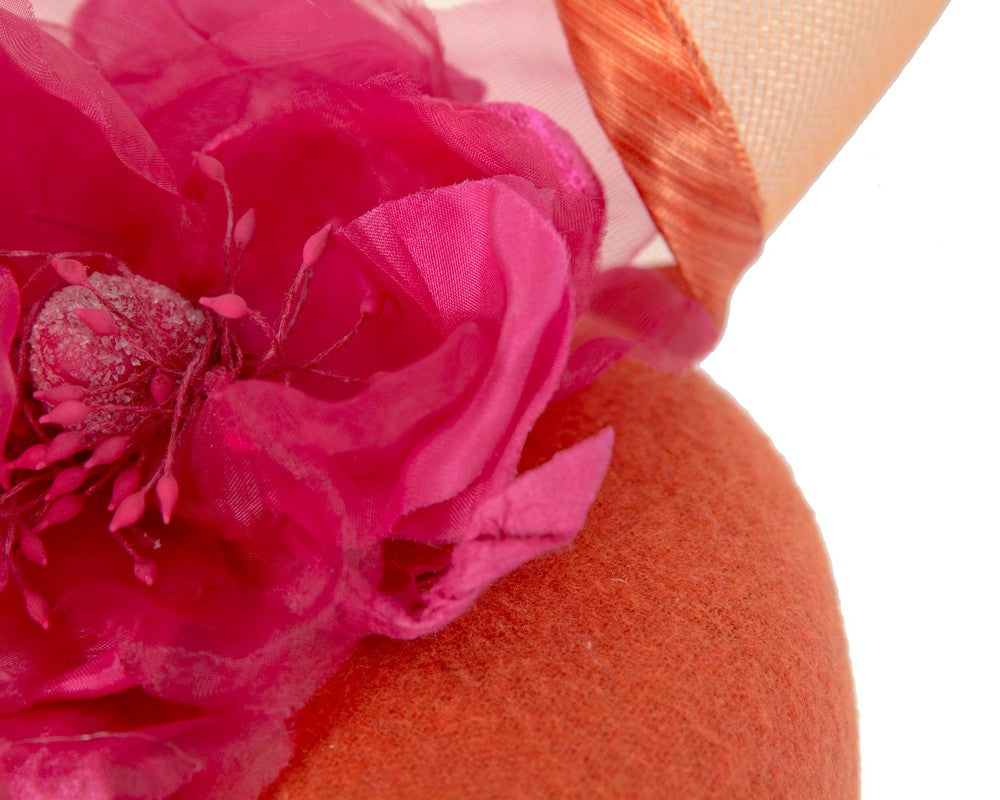 Orange winter pillbox fascinator with fuchsia flower