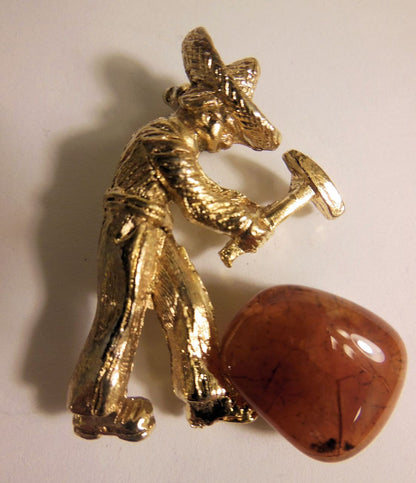 Vintage brooch. At work in the quarry hammering gemstones